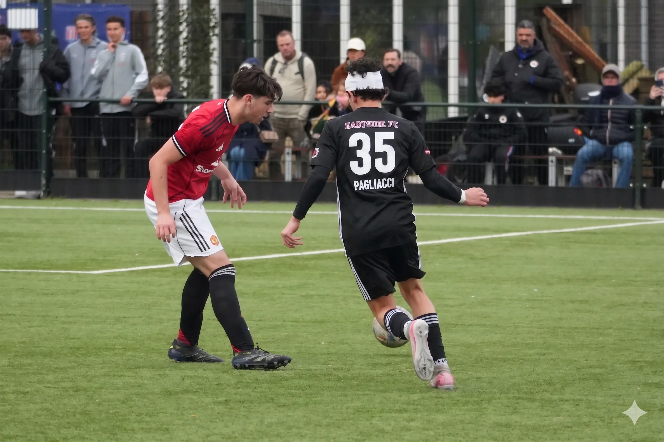 Daylen Hammon in black Real Colorado Eastside FC kit #35 controlling ball vs Manchester United player in red kit at Rotterdam Orange Veins Tournament April 2026